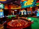 Experience the thrill of ZK88 with poker chips and a spinning roulette wheel in an elegant casino scene.