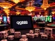 Players winning at an upscale casino, showcasing gg88 gaming experience with vibrant tables and interfaces.